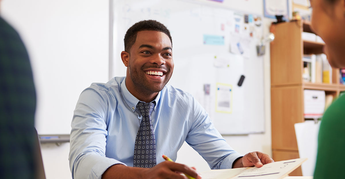male teacher working with student